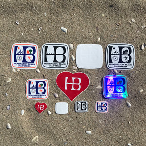 Multi pack of HB stickers - Huntington Beach, California - Printed on high quality vinyl, UV protected, these stickers will hold their colors nicely for a very long time. Pack includes one of each of the following stickers: HB heart, Original full color HB, Black white HB with symbols, Black white HB without symbols, Hologram HB, White HB on clear vinyl, Small original full color HB, Mini HB heart, Mini white HB on clear vinyl, Mini black white HB, Mini original full color HB