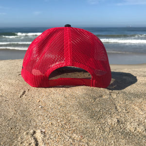 Red embroidered HB in the lower left corner of the front part of this low profile, snapback trucker hat. Huntington Beach California is embroidered on the left side of the hat in black stitching.  5 panel, Low profile, structured firm front panel, pre-curved visor, red mesh back, cotton blend twill front consisting of 65% Polyester and 35% Cotton.
