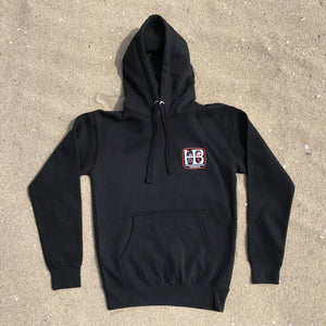 HB Huntington Beach, California Premium Pullover Hoody Black Fleece  White and Orange HB Print, Front and Back 8.5 oz., 3 end fleece, 100% cotton face exterior, 65% cotton 35% polyester blend. Unisex, ultra soft, side seamed, tightly knit, 3 end cotton faced, 3 panel hood, flat draw cords, 2 needle cover stitching at cuffs and waistband, single needle edge stitch at collar, silver gromm.