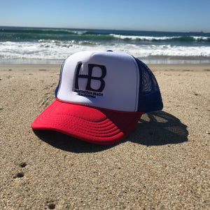 HB Foam Snapback Red/White/Blue Trucker Hat - Embroidered Full Color HB City Logo - HB Puff Blue Stitching - Huntington Beach California Pro Style, 5 Panel, Mid Profile, 100% Polyester Foam Front - 100% Nylon Mesh Back - Plastic Adjustable Snap Back - One Size Fits Most - $25.95.