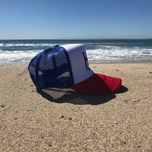 Load image into Gallery viewer, HB Foam Snapback Red/White/Blue Trucker Hat - Embroidered Full Color HB City Logo - HB Puff Blue Stitching - Huntington Beach California Pro Style, 5 Panel, Mid Profile, 100% Polyester Foam Front - 100% Nylon Mesh Back - Plastic Adjustable Snap Back - One Size Fits Most - $25.95. 