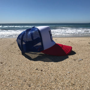 HB Foam Snapback Red/White/Blue Trucker Hat - Embroidered Full Color HB City Logo - HB Puff Blue Stitching - Huntington Beach California Pro Style, 5 Panel, Mid Profile, 100% Polyester Foam Front - 100% Nylon Mesh Back - Plastic Adjustable Snap Back - One Size Fits Most - $25.95. 